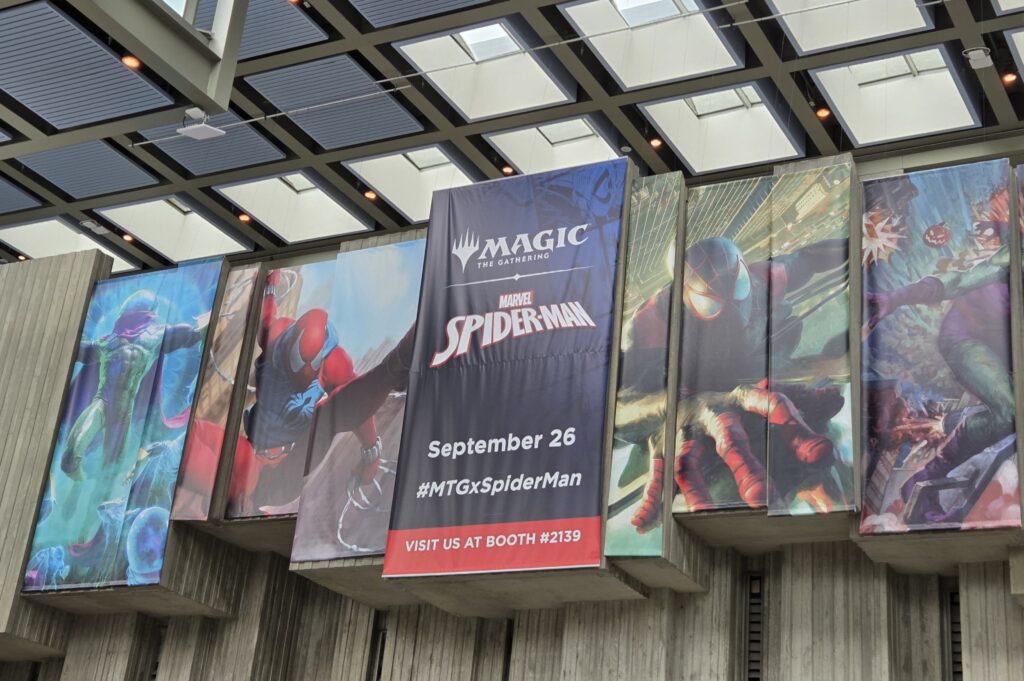 Photograph taken at PAX West 2025, image of a banner for the "MTG x Marvel Spider-man" tabletop game collaboration, with multiple Spiderman characters on the banner.